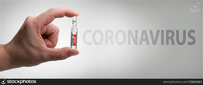 ampoule in a hand with VACCINE, Coronavirus, copy space