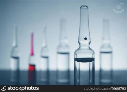 Ampoules with vaccine in blue monochrom