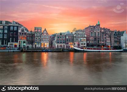 Amsterdam at the river Amstel at sunset in the Netherlands