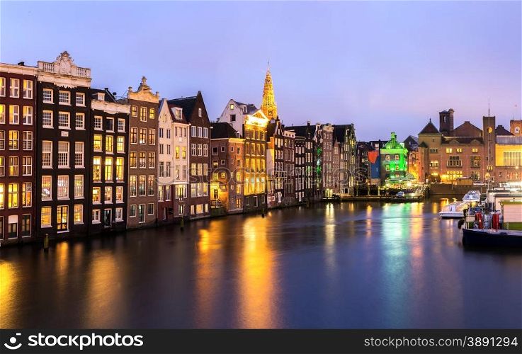Amsterdam Canals and Saint Nicholas church at dusk Natherland