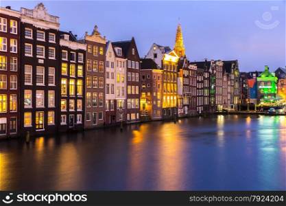 Amsterdam Canals and Saint Nicholas church at dusk Natherland