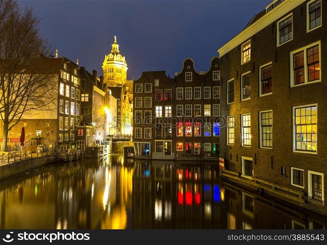 Amsterdam Canals and Saint Nicholas church at dusk Natherlands