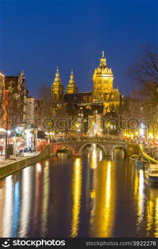 Amsterdam Canals and Saint Nicholas church at dusk Natherlands