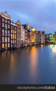 Amsterdam Canals and Saint Nicholas church at dusk Netherlands
