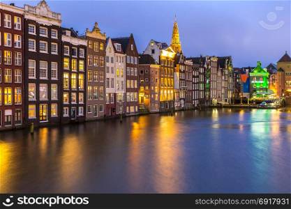 Amsterdam Canals and Saint Nicholas church at dusk Netherlands