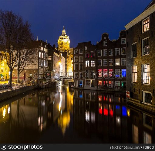 Amsterdam Canals and Saint Nicholas church sunset Netherlands