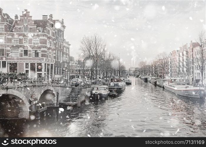 Amsterdam canals view at winter snowstorm. Pastel trendy toning. Beautiful inspiring moody faded scenery