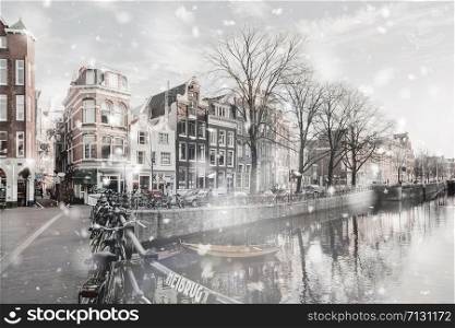 Amsterdam canals view at winter snowstorm. Pastel trendy toning. Beautiful inspiring moody faded scenery