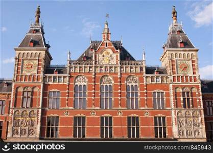 Amsterdam Central Train Station facade in Holland, Netherlands, 19th century Neo-Renaissance and Neo-Gothic style.