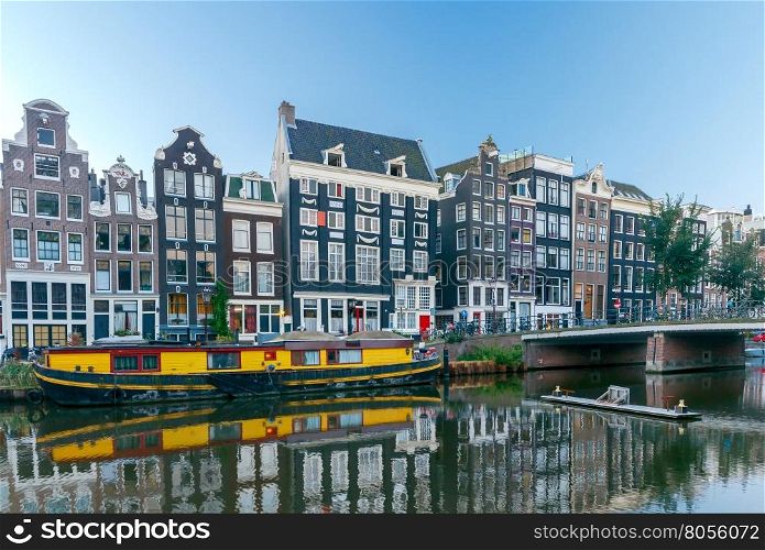 Amsterdam. City Canal at dawn.. City Canal with barges in the early morning. Amsterdam. Netherlands.