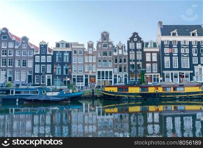 Amsterdam. City Canal at dawn.. City Canal with barges in the early morning. Amsterdam. Netherlands.