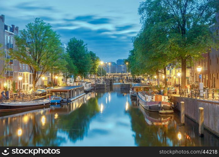 Amsterdam. City Canal at dawn.. City Canal with glowing lights early in the morning. Amsterdam. Netherlands.