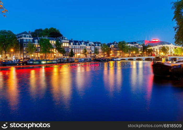 Amsterdam. City Canal at dawn.. City Canal with glowing lights early in the morning. Amsterdam. Netherlands.