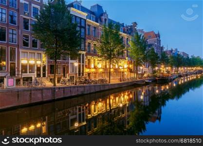Amsterdam. City Canal at dawn.. City Canal with glowing lights early in the morning. Amsterdam. Netherlands.