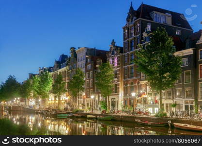 Amsterdam. City Canal at dawn.. City Canal with glowing lights early in the morning. Amsterdam. Netherlands.