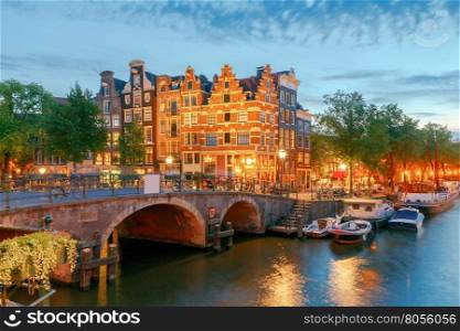 Amsterdam. City Canal at night.. A view of the picturesque canal and facade of the traditional Dutch houses. Amsterdam. Netherlands.