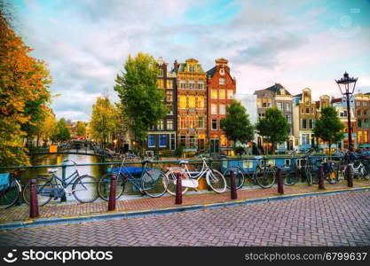 Amsterdam city view with canals and bridges in the evening