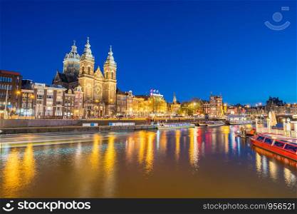 Amsterdam city with Saint Nicholas church and canal in Amsterdam city, Netherlands.