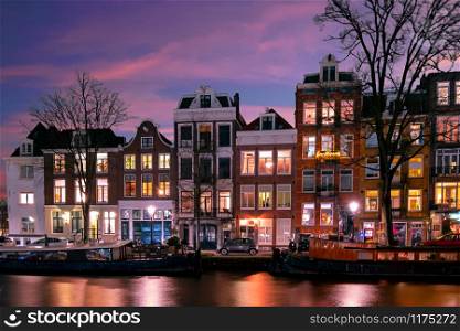 Amsterdam houses along the canal in the Netherlands at sunset