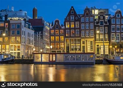 Amsterdam houses and house boats along the Amstel in Amsterdam the Netherlands at sunset