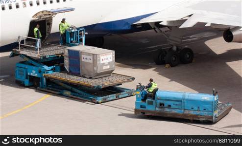 AMSTERDAM - MAY 11: Boeing 767-332ER of Delta is being loaded by ground personal before taking off from Schiphol airport located in Amsterdam, on May 11, 2012, Amsterdam, The Netherlands.