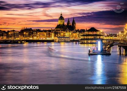 Amsterdam, Netherlands, Holland - December 2019: Pleasure boat on the city&rsquo;s water channels. river IJ. View over the skyline of Amsterdam during sunset