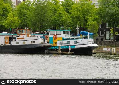 Amsterdam, Netherlands - June 20, 2015: Boats on a canal in Amsterdam. Netherlands