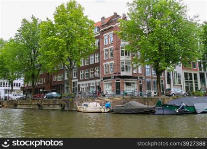 Amsterdam, Netherlands - June 20, 2015: Boats on a canal in Amsterdam. Netherlands