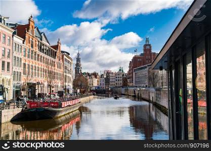 AMSTERDAM, NETHERLANDS - MARCH 4, 2016 : View of Amsterdam City Center with Munt Tower and flower market in Netherlands
