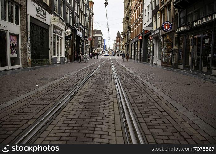 Amsterdam, Netherlands - September 05 2016: Trams in traffic on a street of the city, summer time, toruism in Europe