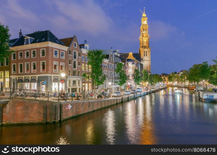 Amsterdam. Night view of the houses along the canal.. Facades of traditional Dutch houses on the canal in the night light. Amsterdam. Netherlands.