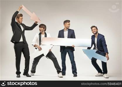 Amused guys holding arrows and boards