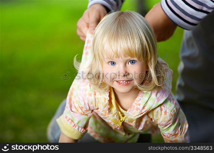 Amusing small blonde girl with blue eyes