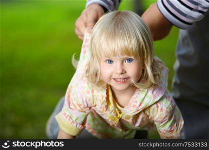 Amusing small blonde girl with blue eyes