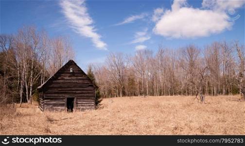 An abandoned cabin stands still after occupants are long gone