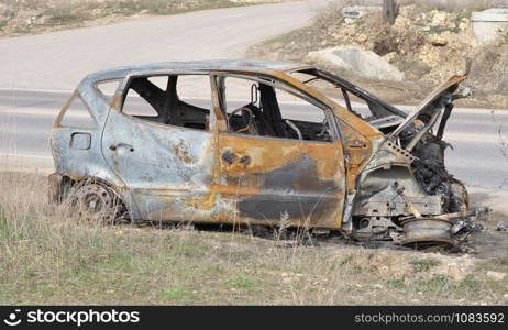 An abandoned, stolen burnt out car