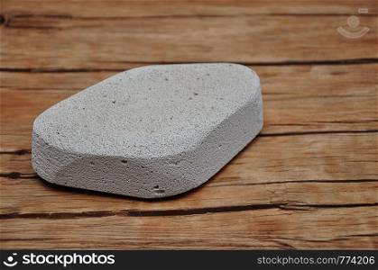 An abrasive stone to remove dry skin from heel