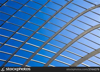 An abstract background texture of a lattice structure highlighted against a deep blue sky.