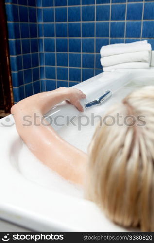 An abstract detail of a woman in a spa bath, shallow depth of field - focus on hand