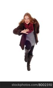 An acting young woman in a winter coat and boots with a burgundy scarf,isolated for white background.