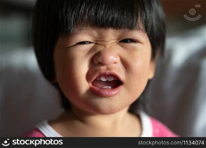An adorable little girl Laughing and big smile in the morning. Concept of happy childhood