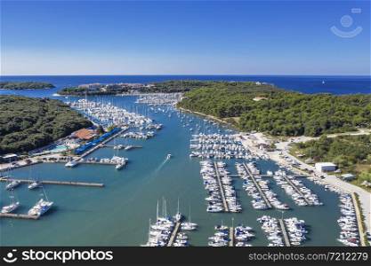 An aerial shot of Verudela peninsula with yachts and boats in Pula, Istria, Croatia