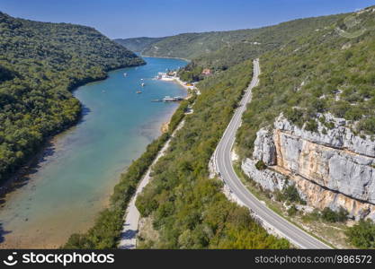 An aerial view of Limski Kanal with vertical climbing rock mountain