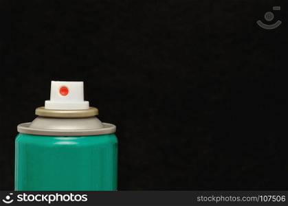 An aerosol can isolated against a black background