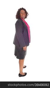 An African American business woman standing in profile isolated forwhite background and smiling.