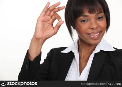 An African American businesswoman gesturing an ok sign.