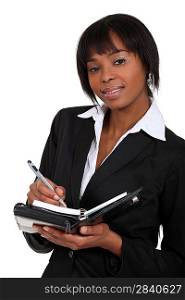 An African American businesswoman with a planner.