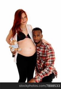 An African American man holding his ear on his wife&rsquo;s baby belly,isolated for white background.