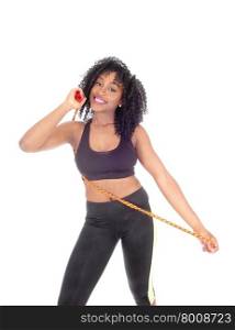 An African American woman in exercise outfit with a rope, smiling, standing isolated for white background in black sports clothing.