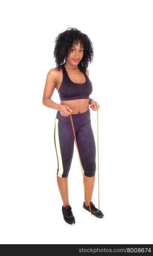 An African American woman in exercise outfit with a rope standingisolated for white background.